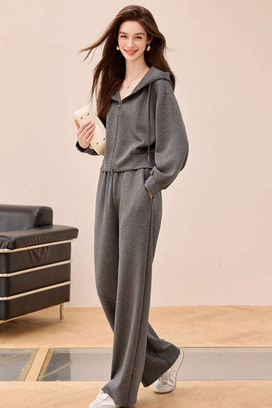 Standing model in gray wide-leg jumpsuit with side pockets and relaxed fit
