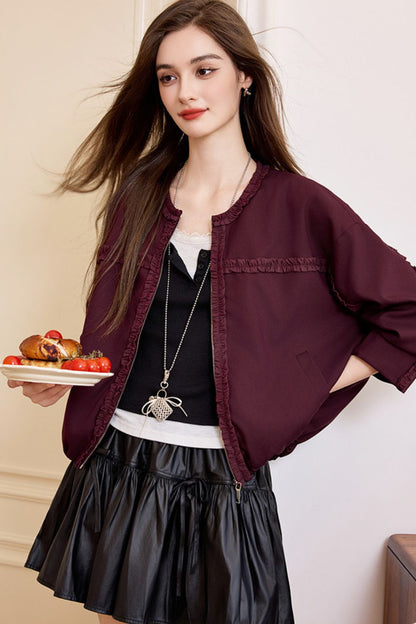 Side view of burgundy jacket styled with skirt