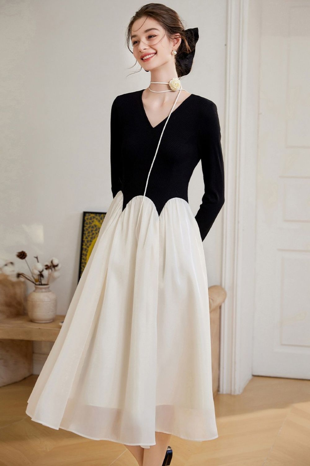 Side view of two-tone black and white midi dress