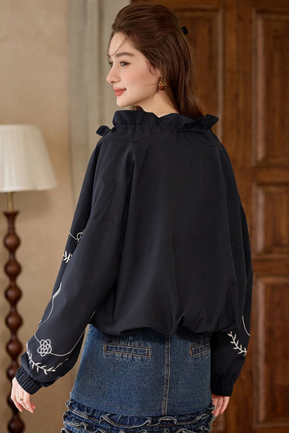 Back view of black embroidered jacket with scalloped hem