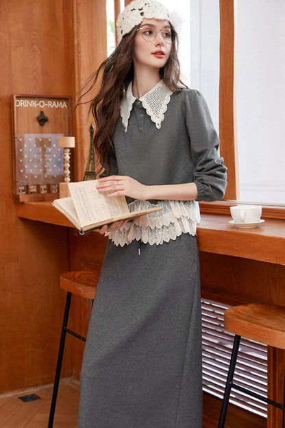 Model holding book, styled in gray lace-trimmed blouse and skirt with crochet hat